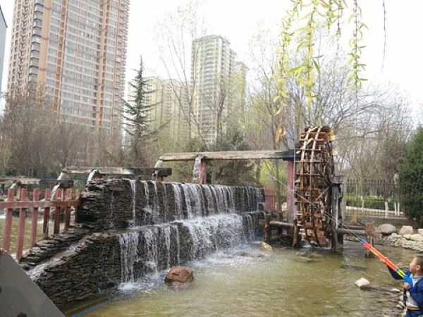 兰州水车博览园，巨大的木质水车矗立在黄河边，展示古代灌溉智慧，水车转动时水花飞溅